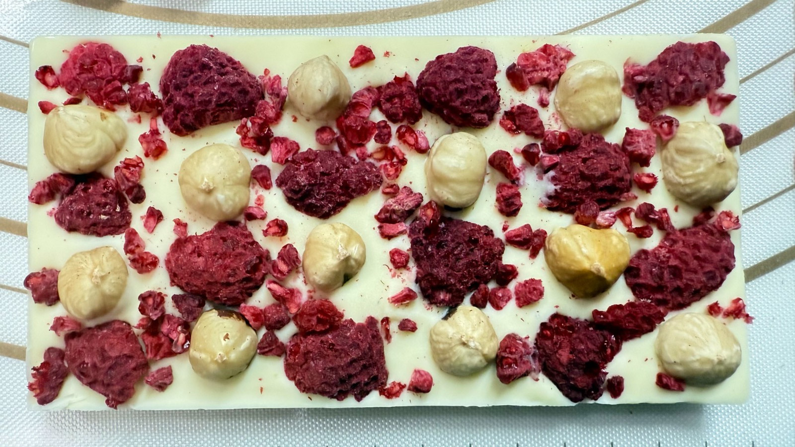 White Chocolate Bar Sweet & Sour taste Raspberry & Hazelnut on top 100g .